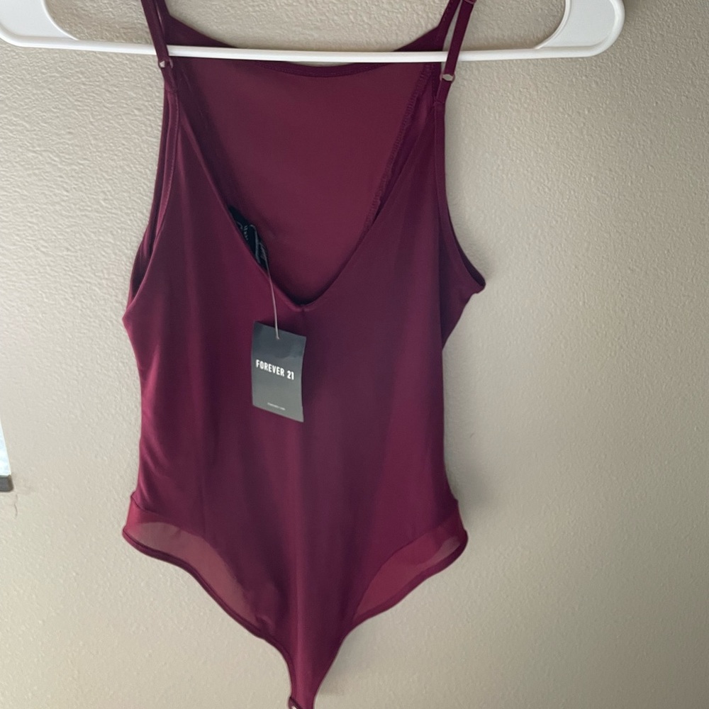 NWT. Forever 21 bodysuit. Wine/Maroon color. Mesh in the front!